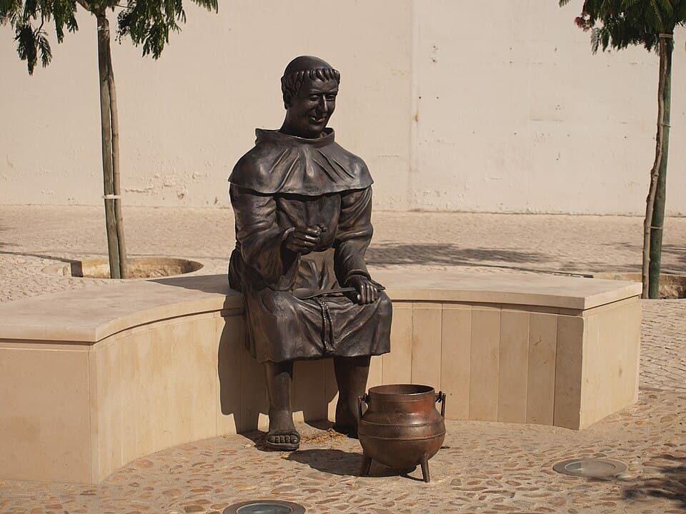 Estátua de um frade com a panela da sopa da pedra em Almeirim