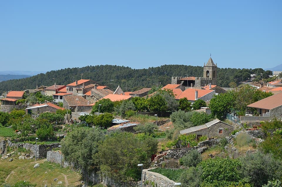 Vista sobre o casario de Penamacor e a torre sineira entre colinas arborizadas